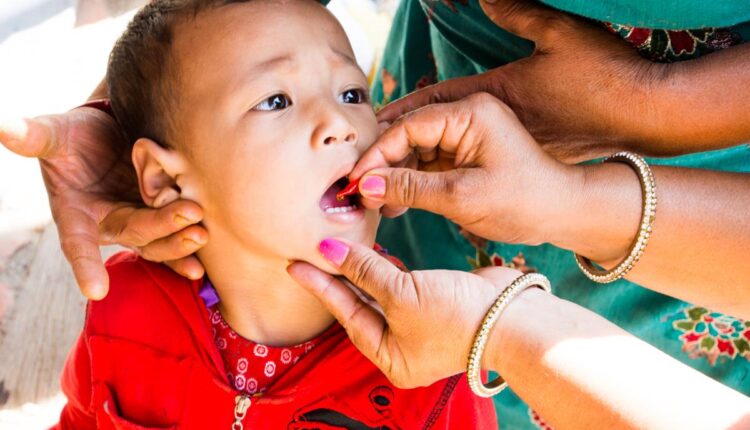 Vitamin-A being administered to a child.